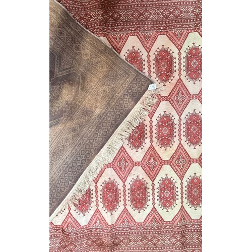 420 - A Caucasian style rug, worked with stylised guls, orange on cream ground, 135cm x 195cm