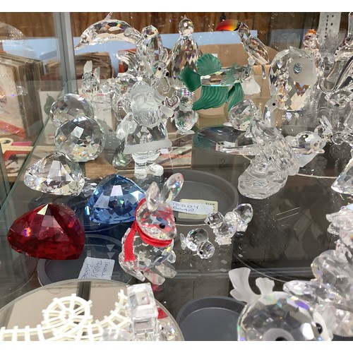 55 - A good collection of approximately 53 Swarovski crystal figures, including a great white shark, a Ch... 