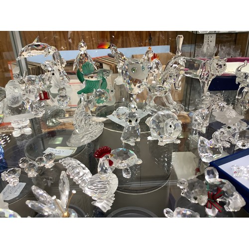 55 - A good collection of approximately 53 Swarovski crystal figures, including a great white shark, a Ch... 