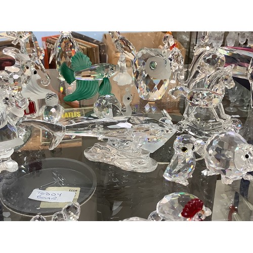 55 - A good collection of approximately 53 Swarovski crystal figures, including a great white shark, a Ch... 