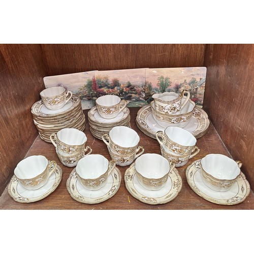 43 - A twelve setting Noritake part tea service, comprising cups, saucers, plates, platters, a jug and a ... 