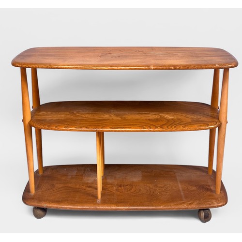 566 - A mid-20th century blonde beech and elm Ercol baby giraffe trolley/bookcase from the Windsor range, ... 