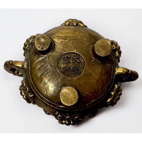 73 - A small cast bronze censor and cover of organic form with rustic handles, Xuande four character mark... 