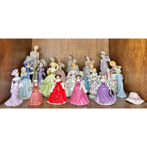 50 - A collection of twenty-two assorted ceramic figures, predominantly modelled as ladies in fine gowns,... 