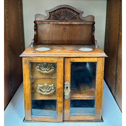 569 - An early 20th Century oak table top/wall hanging smokers cabinet, two glazed doors open to reveal fi... 