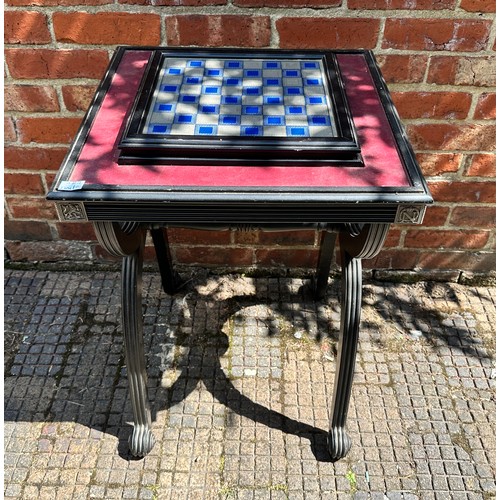 353 - A Napoleonic themed pewter chess set with board, raised on ornate x-frame table, 51cm diameter