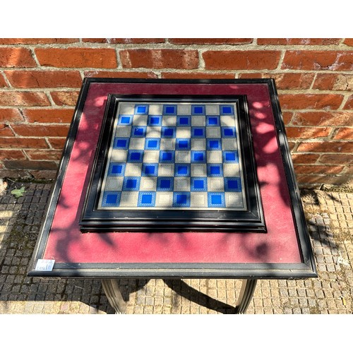 353 - A Napoleonic themed pewter chess set with board, raised on ornate x-frame table, 51cm diameter