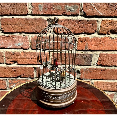 358 - A 20th century singing bird automaton modelled as a birdcage housing two birds, one red and one yell... 