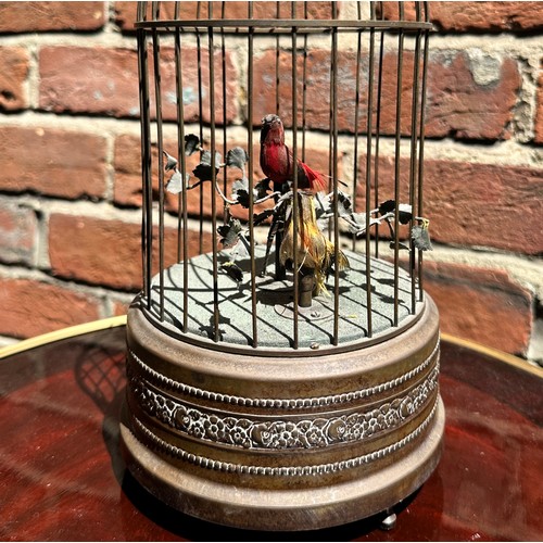 358 - A 20th century singing bird automaton modelled as a birdcage housing two birds, one red and one yell... 