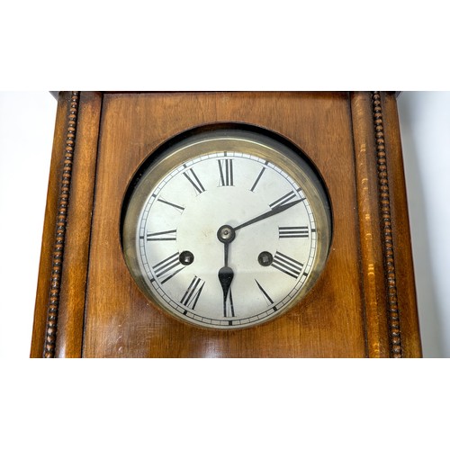 274 - A 20th Century walnut cased Vienna wall clock, circular brass dial with enamel chapter ring bearing ... 