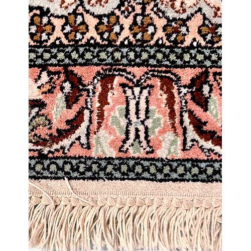 284 - A small hand-knotted Persian rug, worked with a central medallion in garden with vases of flowers an... 