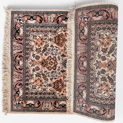 284 - A small hand-knotted Persian rug, worked with a central medallion in garden with vases of flowers an... 