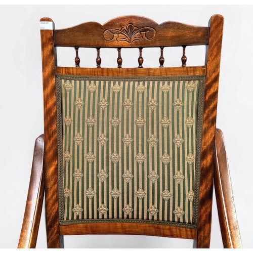 346 - An oak rocking chair, curved wood frame, green pinstripe upholstered seat and back, a rush-seated ch... 