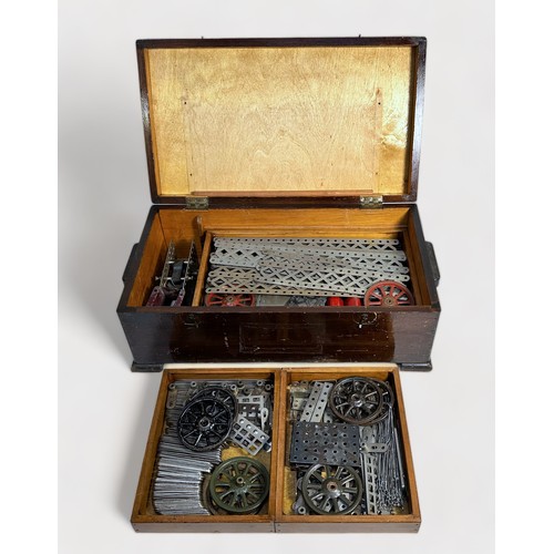 560 - An early 20th century wooden cased Meccano Engineering for Boys outfit no. 2 with removable shelves ... 