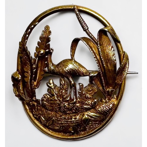 130 - A yellow metal, tests as 14ct gold oval brooch, pierced and worked with an Emu amidst foliage, 36mm ... 