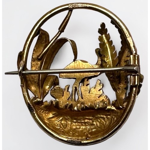 130 - A yellow metal, tests as 14ct gold oval brooch, pierced and worked with an Emu amidst foliage, 36mm ... 