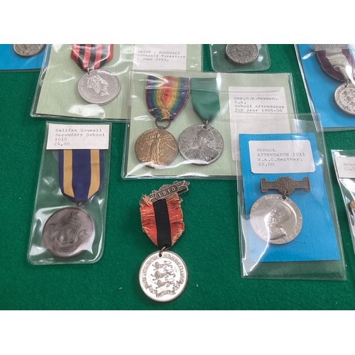 417 - A collection of military and other buttons and school attendance medals, some with the prices paid b... 