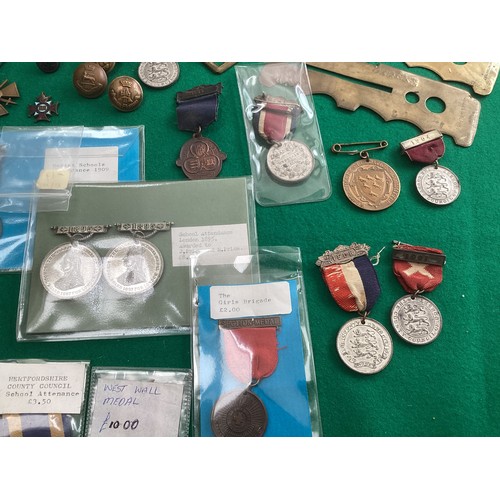 417 - A collection of military and other buttons and school attendance medals, some with the prices paid b... 