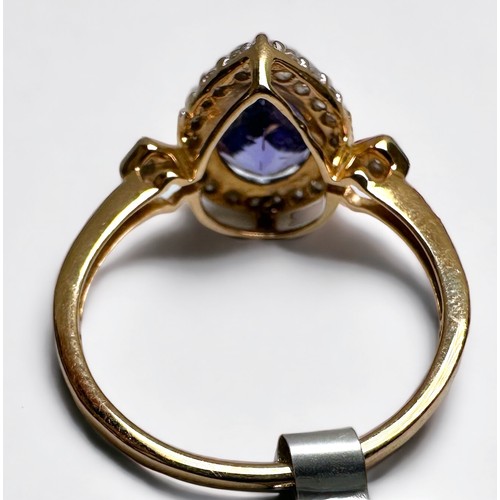 156 - A 10ct yellow gold ring, set with a pear shaped tanzanite, halo set with small white stones, togethe... 