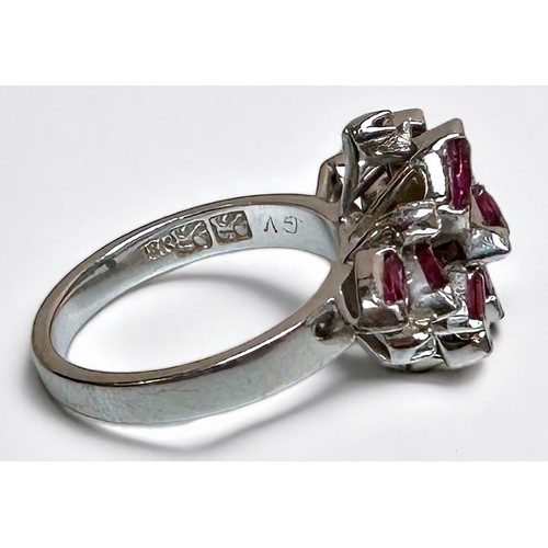 175 - An 18ct white gold dress ring, claw set with 9 x marquise-cut rubies, 2 x emerald-cut rubies, and 6 ... 