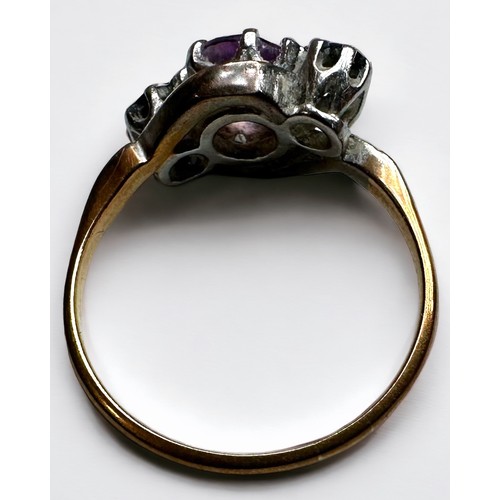 187 - An 18ct gold and platinum dress ring, set with an amethyst to the centre, flanked by a diamond to ea... 