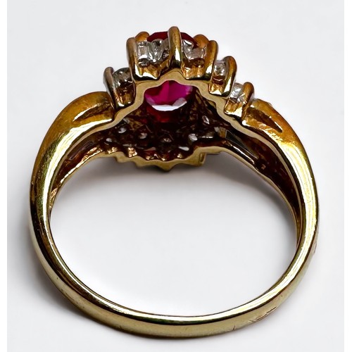 190 - An 18ct yellow gold ruby and diamond ring, set with an oval faceted ruby to the centre, (possibly la... 