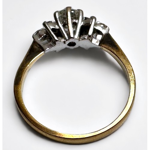 194 - An 18ct yellow gold and rhodium plated diamond ring, claw set with a round brilliant cut diamond, to... 