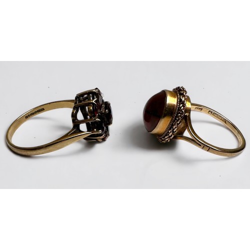 202 - Two 9ct yellow gold dress rings, set with garnet and amber, total weight 5.5 grams.