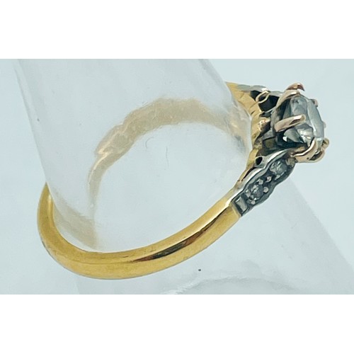 219 - An 18ct yellow gold and platinum ring, claw set with a round brilliant cut diamond to the centre, es... 