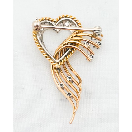 209 - An 18ct yellow and white gold diamond heart-shaped brooch, in a scroll and spray design, with 15 x g... 