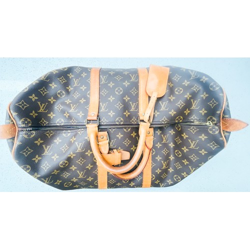 263 - A Louis Vuitton monogram holdall, 40, with tan leather luggage tag, brass hardware, zip broken.