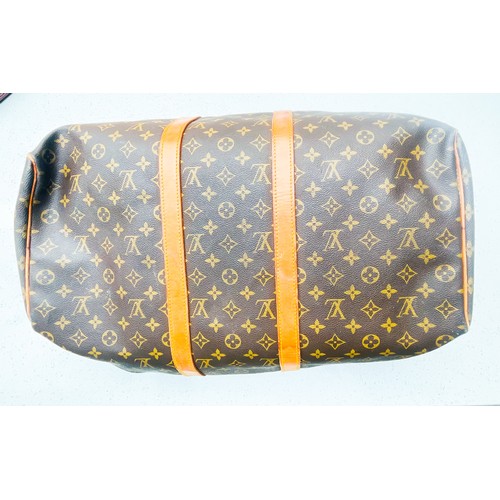 263 - A Louis Vuitton monogram holdall, 40, with tan leather luggage tag, brass hardware, zip broken.