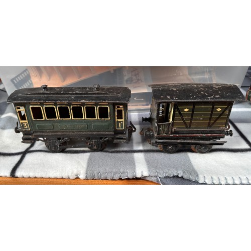 727 - A collection of assorted tinplate ‘O’ gauge railway including two locomotives, probably Bing and a s... 