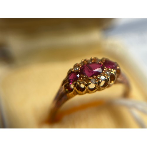 186 - An 18ct gold Victorian style, ruby and diamond ring, set with 3 x oval faceted rubies, surrounded by... 