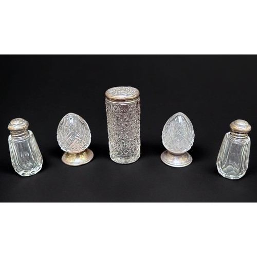 34 - A collection of silver and silver-plate topped and collared toilette bottles and jars, comprising cu... 