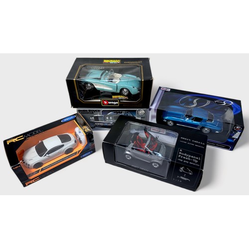 248 - A collection of seven boxed assorted die-cast 1:18 scale model vehicles, comprising, American Muscle... 