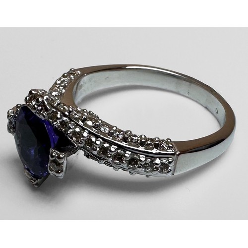 68 - An 18ct white gold dress ring, set with a round faceted tanzanite to the centre, with 3 x rows of pa... 