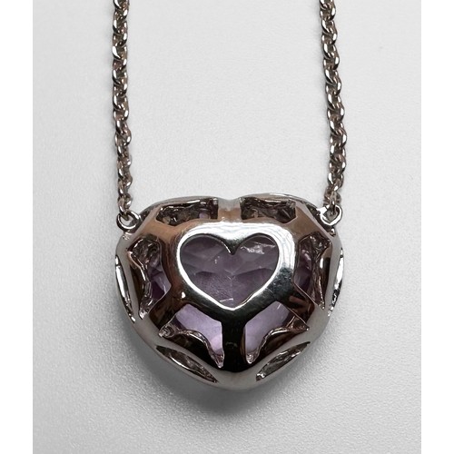 74 - An 18ct white gold necklace, claw set with a heart shaped faceted amethyst to the centre, in a diamo... 