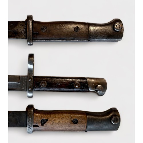 433 - An M1895 Mannlicher bayonet by Ernst Busch, with metal scabbard, together with two Spanish K98 model... 