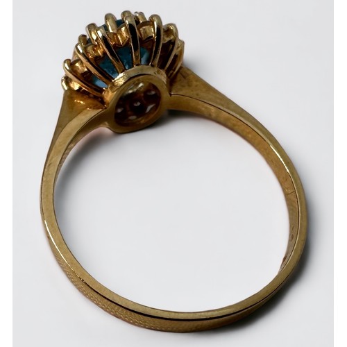 90 - An 18ct yellow gold cluster dress ring, set with an oval-shaped blue topaz to the centre, surrounded... 