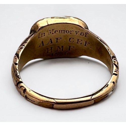 115 - A yellow metal, tests as 14ct gold memorial ring, with chased floral engraving to the shoulders and ... 