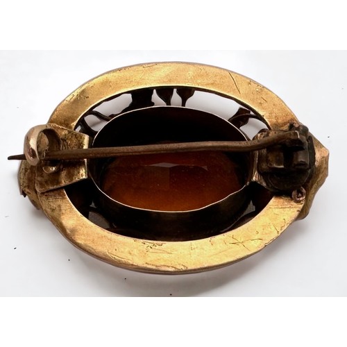 116 - A yellow metal, tests as 14ct gold, brooch, set with a large oval-shaped faceted stone to the centre... 