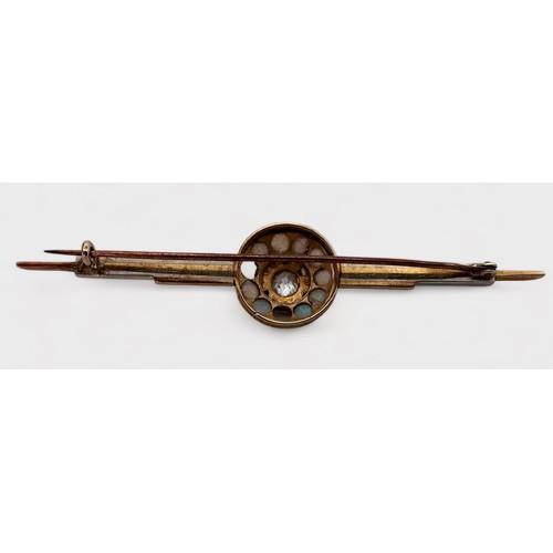 117 - A yellow and white metal bar brooch, tests as 14ct gold, cluster set to the centre with a an old cut... 