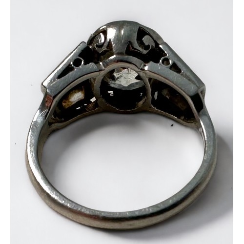 109 - A platinum and diamond ring, rub-over set with an oval-shaped Victorian cut diamond to the centre, e... 