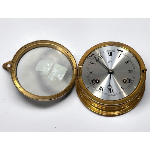 519 - A brass cased bulkhead clock by Barigo, with alarm function and silvered dial denoting hours, 15cm d... 