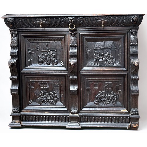 295 - A 19th century Flemish oak court cupboard, the moulded cornice over a carved frieze with lion's mask... 