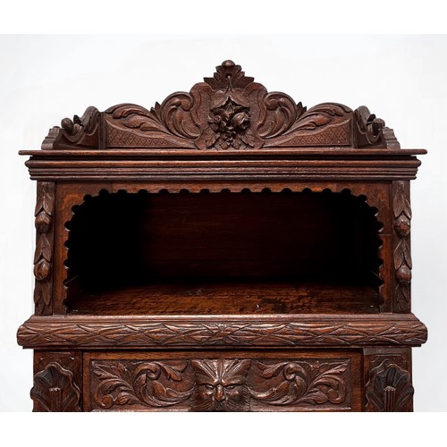 294 - An ornately carved 19th century oak Flemish chest of drawers, with carved three-quarter gallery and ... 