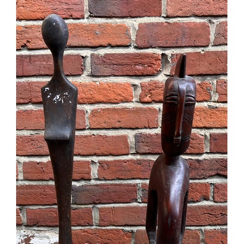 187 - Two African carved hardwood stylised figures of elongated form, 124cm and 116cm high