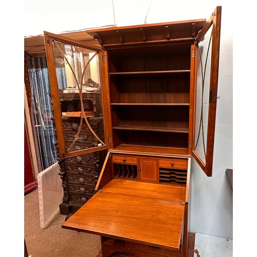 288 - A Liberty 'style' oak bureau bookcase, the top with adjustable shelves enclosing by glazed doors, sl... 