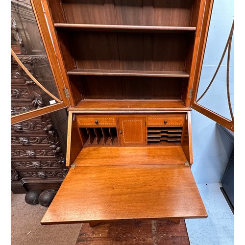 288 - A Liberty 'style' oak bureau bookcase, the top with adjustable shelves enclosing by glazed doors, sl... 